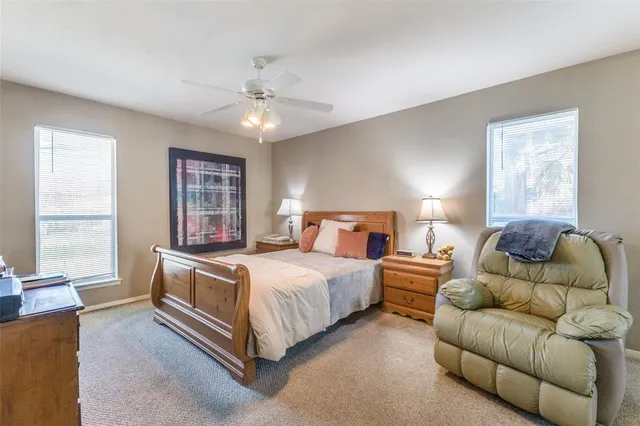 a bedroom with a bed couch and window