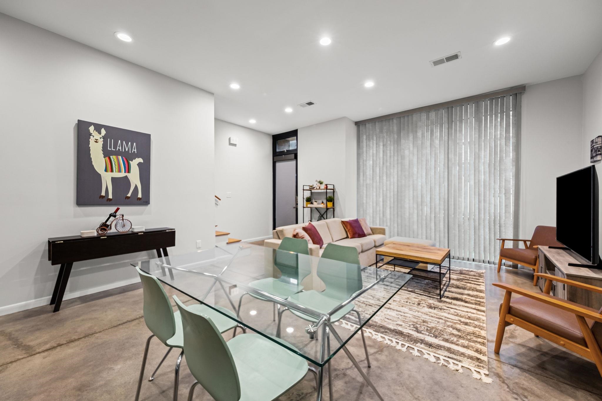 448 Tennessee Street Memphis, TN 38103 - Photo 34 of 39 Open-concept room featuring concrete flooring, recessed lighting, and a large window with vertical blinds