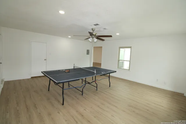 a living room with hard wood floors and a table