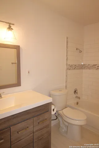 a bathroom with a toilet a sink and bathtub
