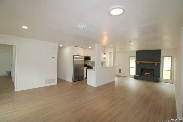 a view of kitchen with furniture and wooden floor
