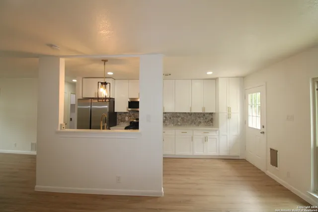 a view of a kitchen cabinets and wooden floor