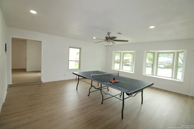 a workspace with wooden floor and a window