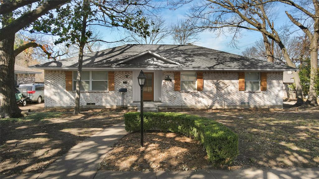 8489 Banquo Drive Dallas, TX 75228 - Photo 1 of 1 a front view of a house with garden