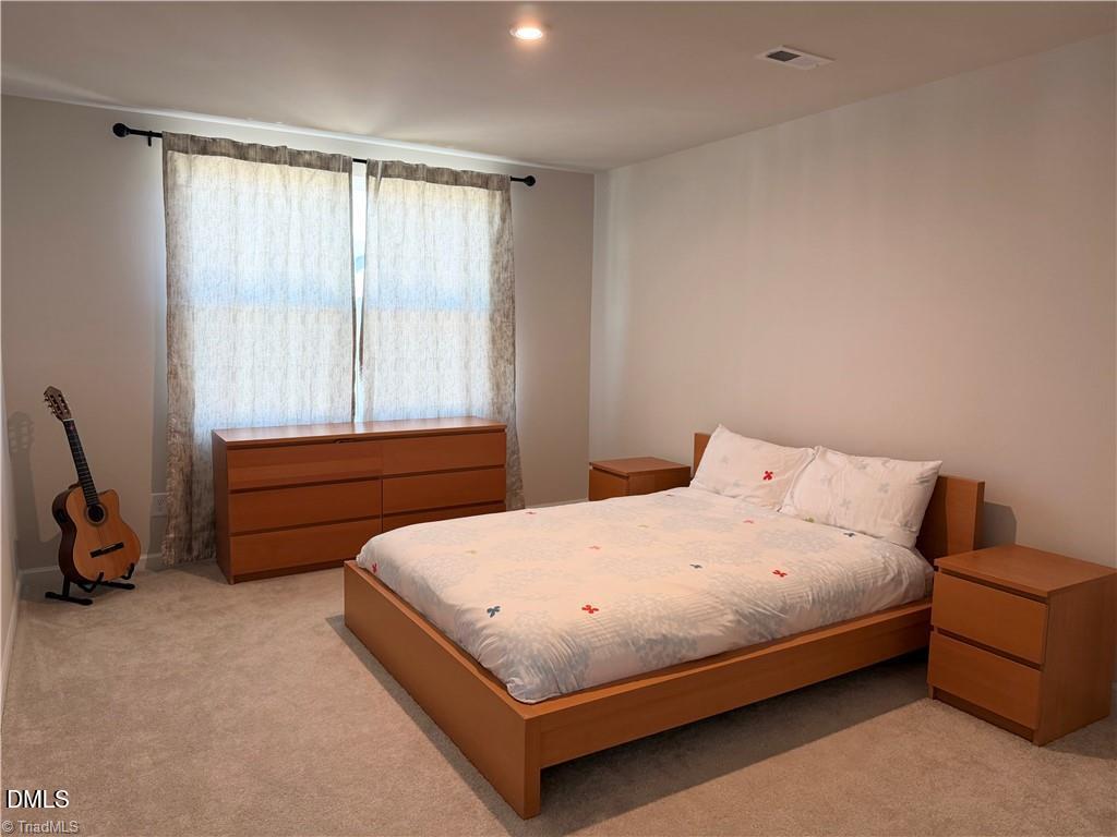 6840 Tarik Lane Raleigh, NC 27610 - Photo 11 of 27 a bedroom with a bed a table and chair