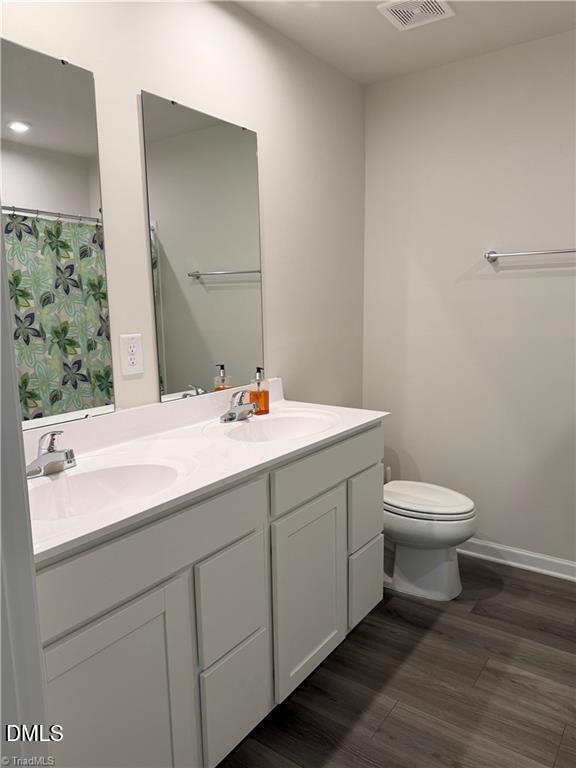 6840 Tarik Lane Raleigh, NC 27610 - Photo 13 of 27 a bathroom with a sink and a toilet