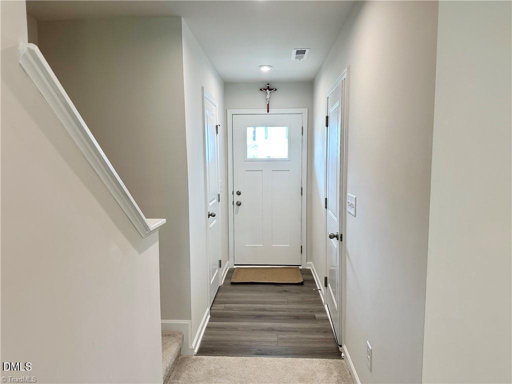 6840 Tarik Lane Raleigh, NC 27610 - Photo 5 of 27 a view of a hallway with wooden floor and staircase