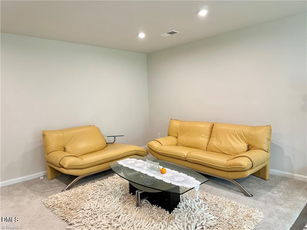 6840 Tarik Lane Raleigh, NC 27610 - Photo 6 of 27 a living room with a couch and a rug