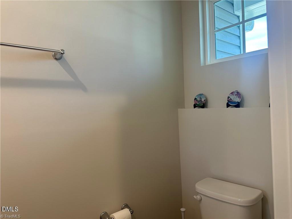 6840 Tarik Lane Raleigh, NC 27610 - Photo 10 of 27 a bathroom with a toilet and a shower