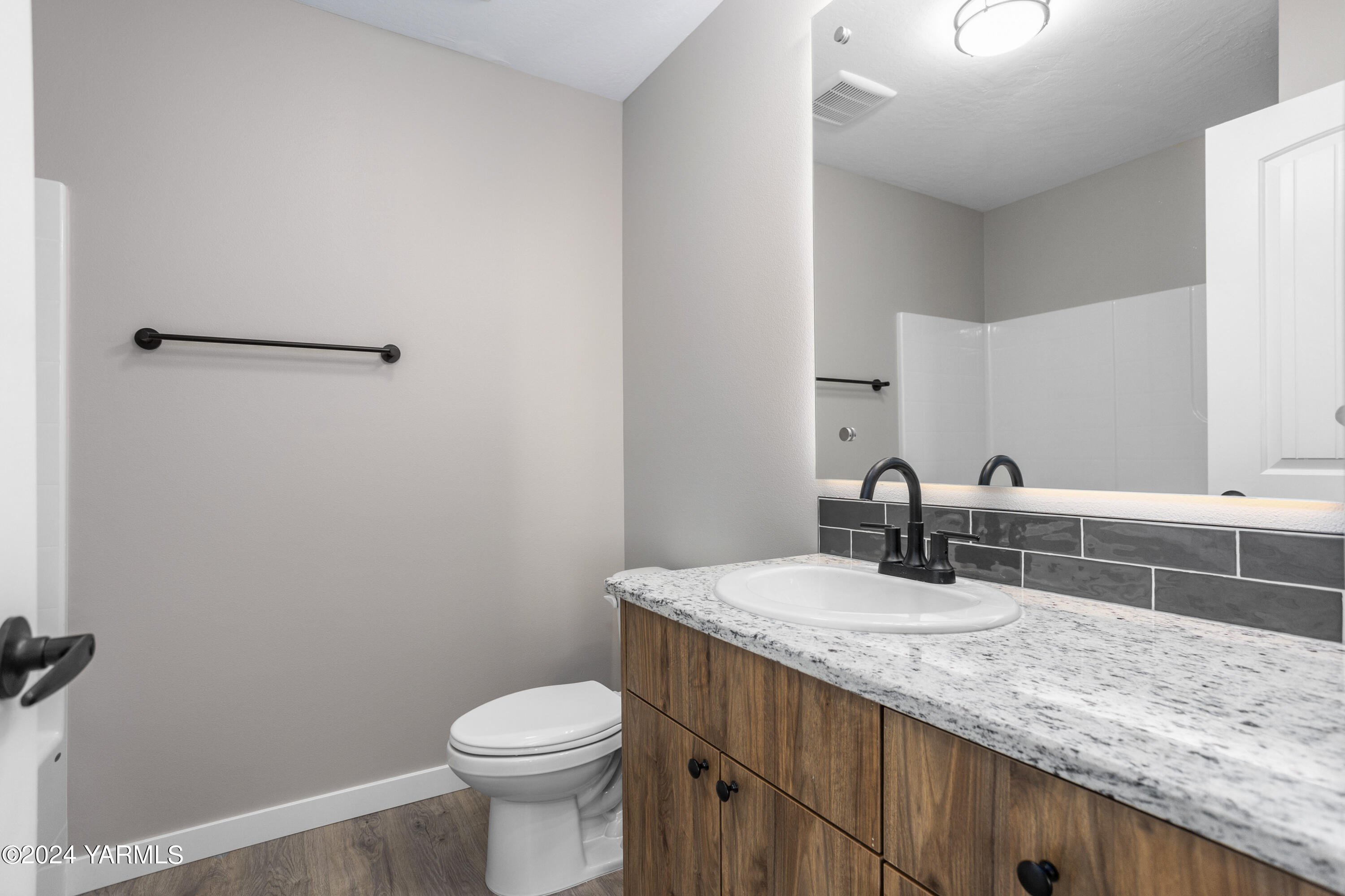 116 Scott Road Prosser, WA 99350 - Photo 14 of 38 a bathroom with a granite countertop toilet sink and mirror