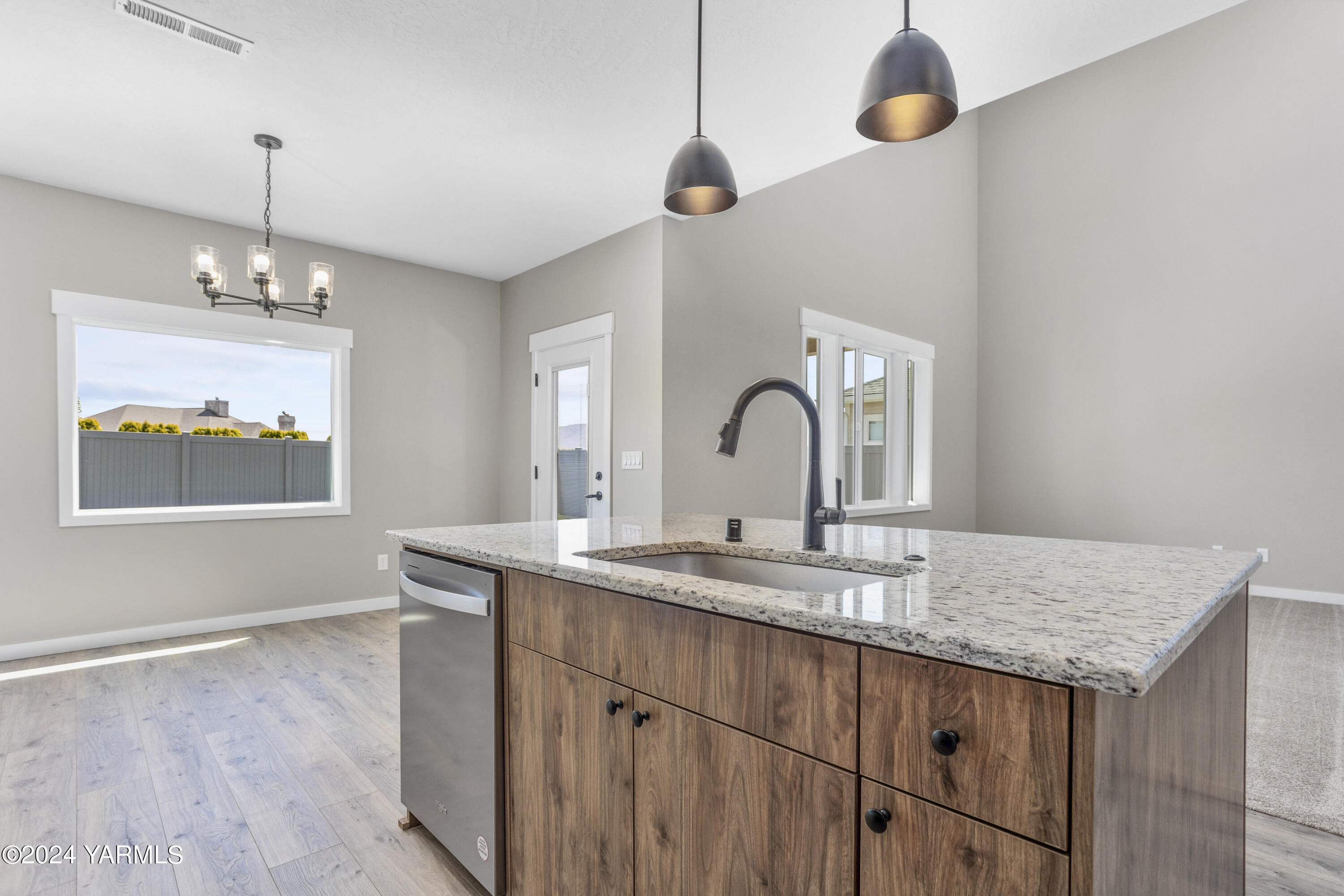 116 Scott Road Prosser, WA 99350 - Photo 5 of 38 a kitchen with kitchen island a sink and wooden floor