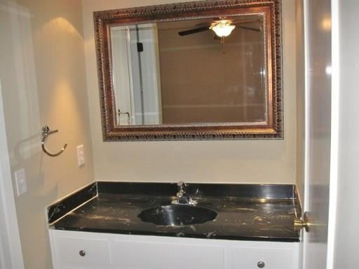 9807 Mountain Quail Road Austin, TX 78758 - Photo 11 of 19 a bathroom with a sink and mirror