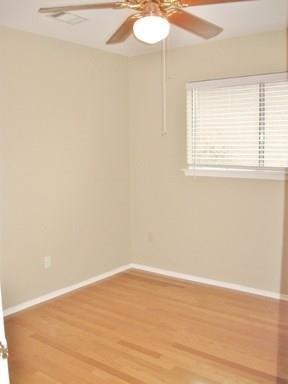 9807 Mountain Quail Road Austin, TX 78758 - Photo 13 of 19 an empty room with wooden floor and windows