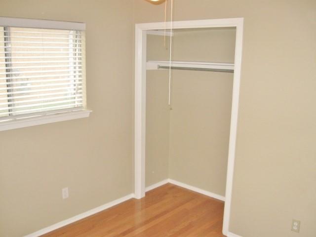 9807 Mountain Quail Road Austin, TX 78758 - Photo 14 of 19 a view of a small space with wooden floor and a window
