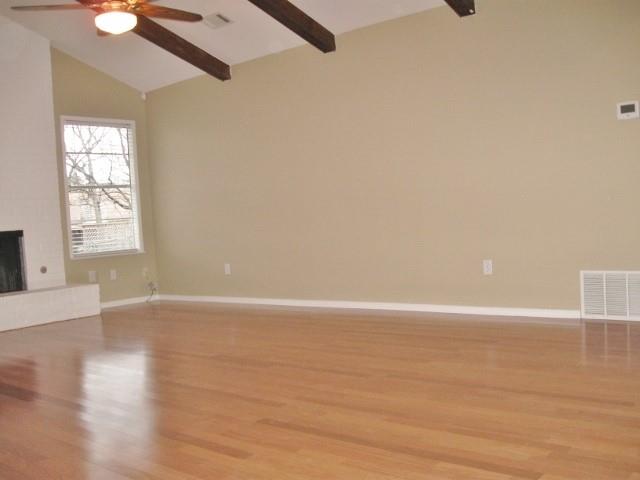 9807 Mountain Quail Road Austin, TX 78758 - Photo 3 of 19 a view of an empty room with wooden floor and a window