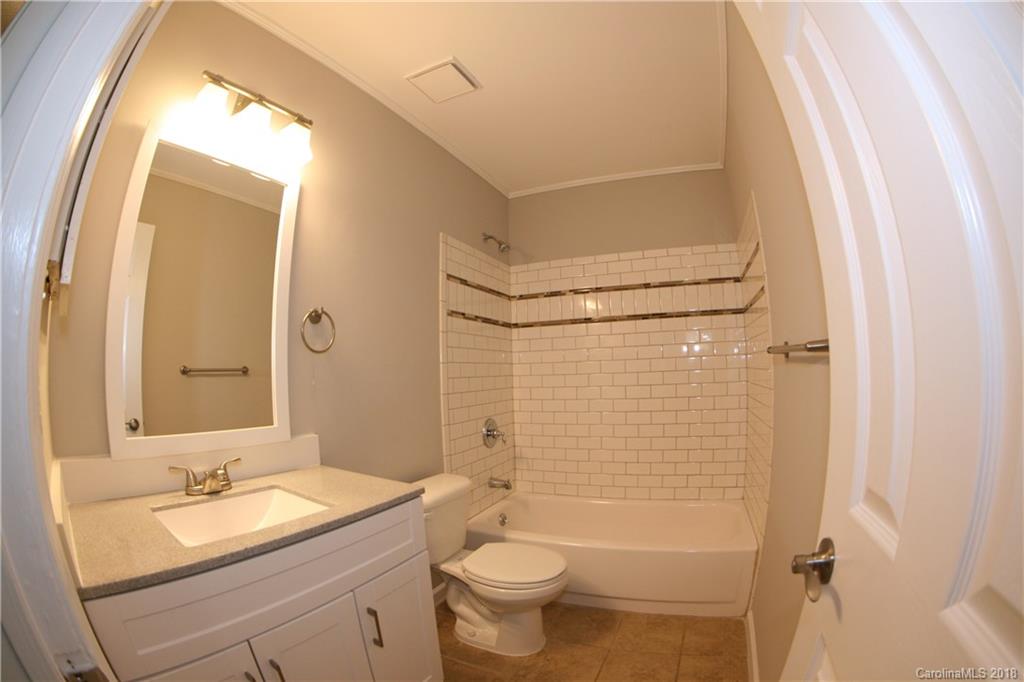 10943 Park Road Charlotte, NC 28226 - Photo 12 of 31 a bathroom with a granite countertop sink toilet and shower