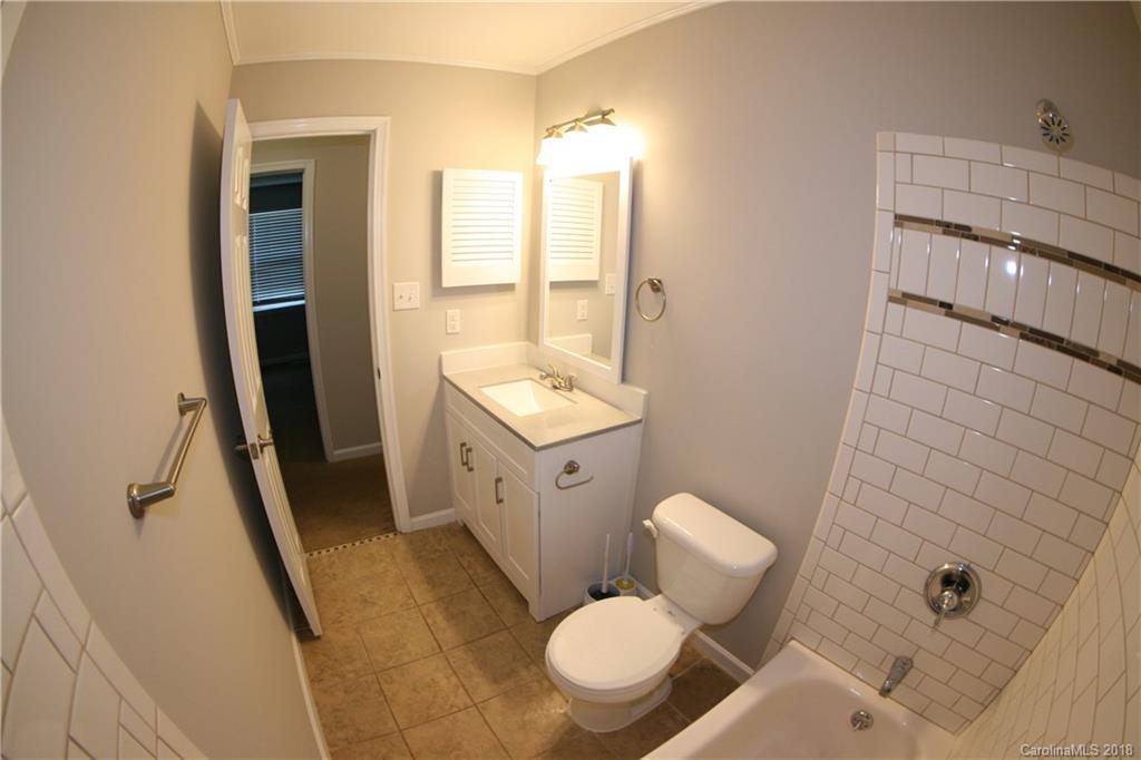 10943 Park Road Charlotte, NC 28226 - Photo 14 of 31 a bathroom with a toilet sink and mirror