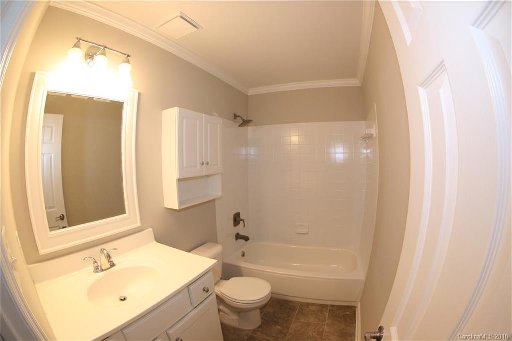 10943 Park Road Charlotte, NC 28226 - Photo 17 of 31 a bathroom with a sink a toilet and shower
