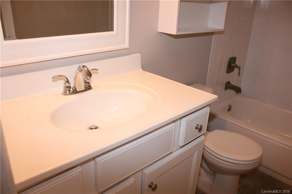 10943 Park Road Charlotte, NC 28226 - Photo 18 of 31 a bathroom with a sink a toilet and shower