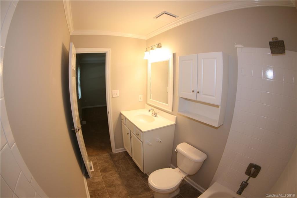 10943 Park Road Charlotte, NC 28226 - Photo 19 of 31 a bathroom with a sink mirror vanity and toilet