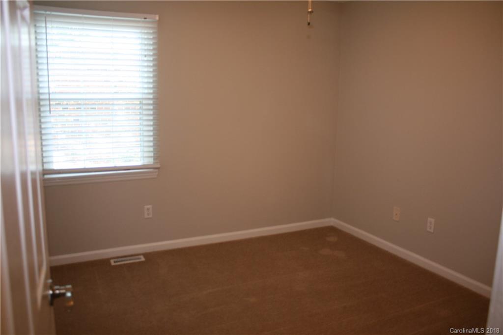 10943 Park Road Charlotte, NC 28226 - Photo 21 of 31 an empty room with a window