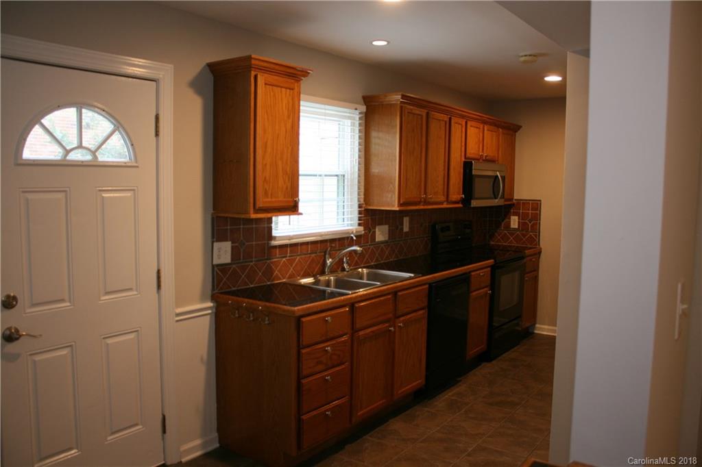 10943 Park Road Charlotte, NC 28226 - Photo 5 of 31 a kitchen with a sink and a window