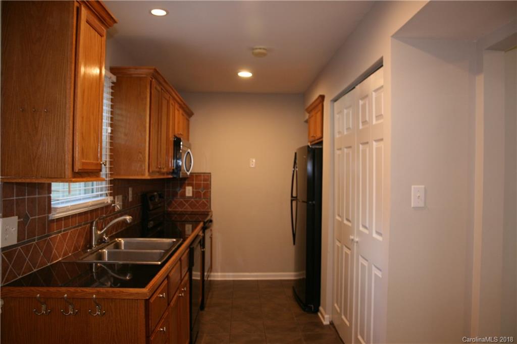 10943 Park Road Charlotte, NC 28226 - Photo 6 of 31 a kitchen with sink and refrigerator