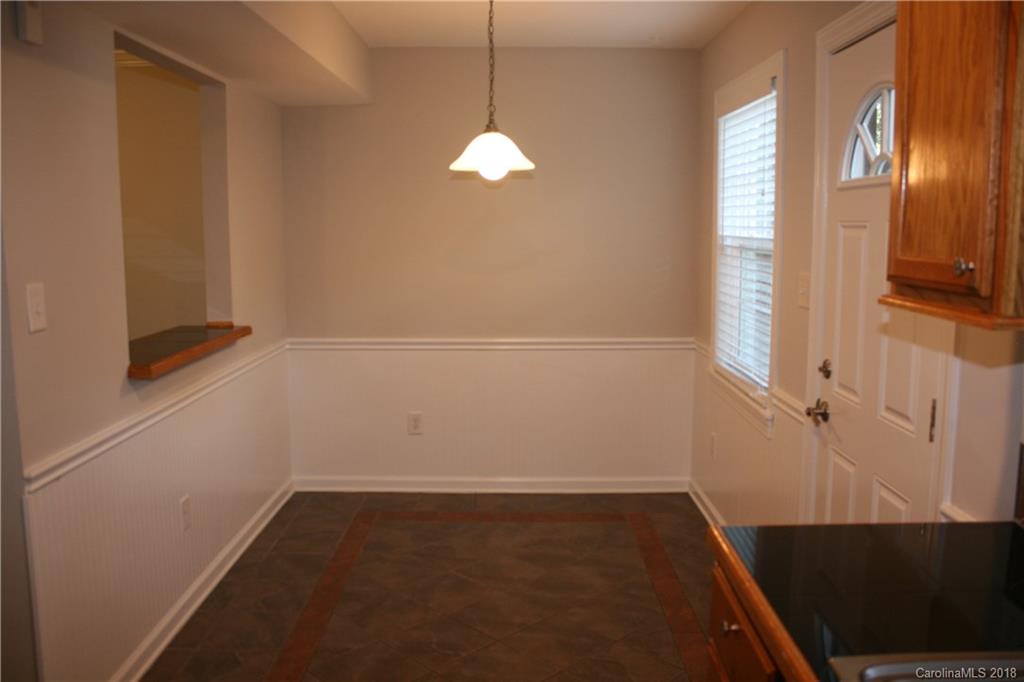 10943 Park Road Charlotte, NC 28226 - Photo 8 of 31 a view of empty room with wooden floor and fan