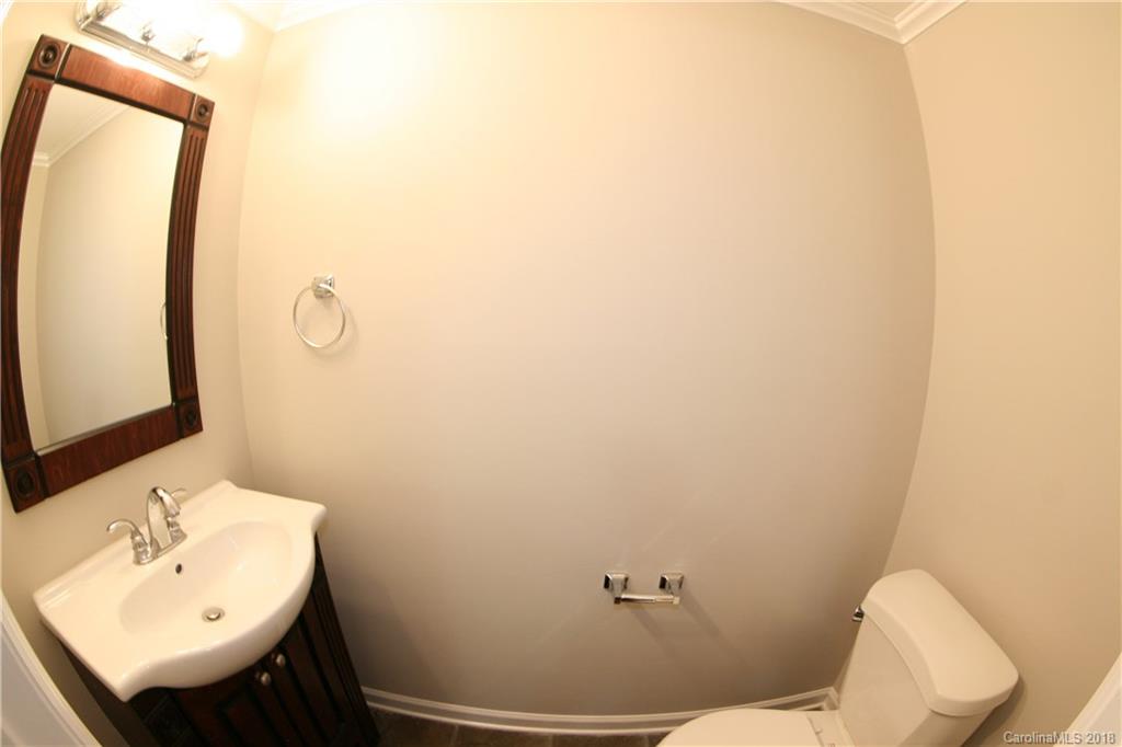10943 Park Road Charlotte, NC 28226 - Photo 10 of 31 a bathroom with a sink mirror and toilet