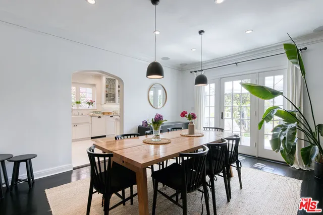 a bedroom with a bed a table and chair