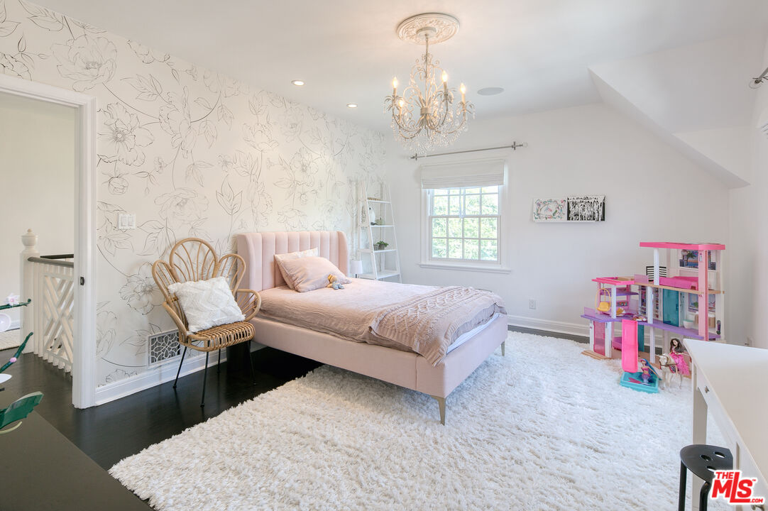 10736 Le Conte Avenue Los Angeles, CA 90024 - Photo 29 of 44 a bedroom with a bed and a chandelier