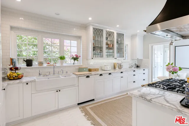 a spacious bedroom with a bed and wooden floor