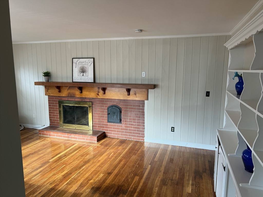 76 Allston Street Lawrence, MA 01841 - Photo 2 of 6 a view of a livingroom with wooden floor and a fireplace