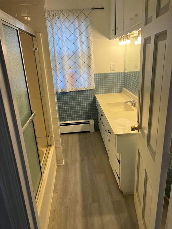 76 Allston Street Lawrence, MA 01841 - Photo 5 of 6 a bathroom with a tub and shower