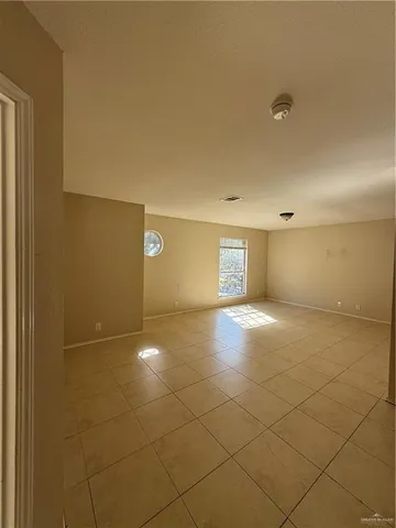 a view of an empty room and a window