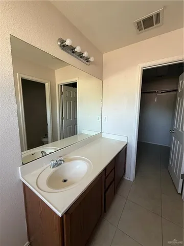 an empty room with a ceiling fan and carpet