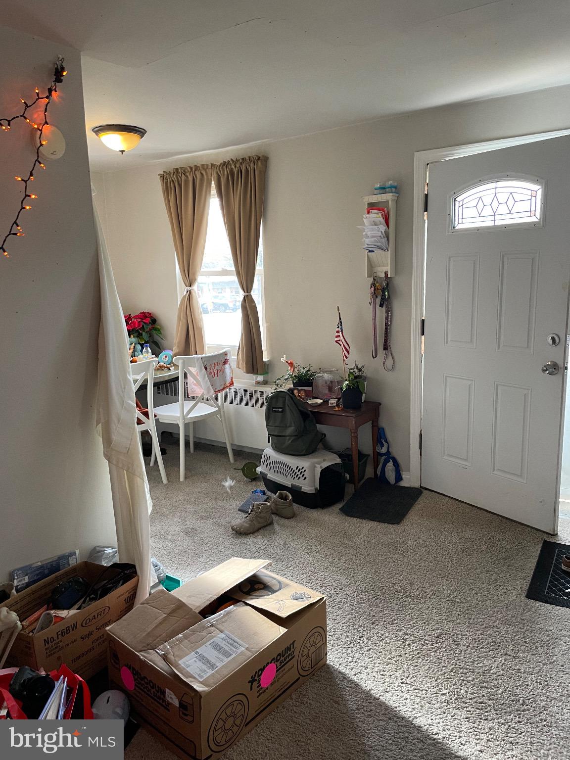 213 Gray Street Chester, PA 19013 - Photo 11 of 38 a living room with furniture a window and a flat screen tv