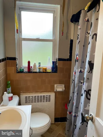 a bathroom with a sink toilet and a window