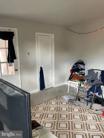 a bedroom with a bed and the mirror