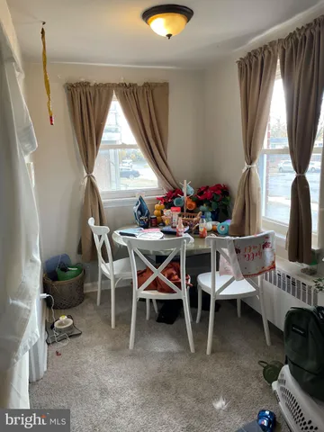 a dining room with furniture and a window