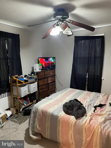 a bedroom with a bed and a mirror