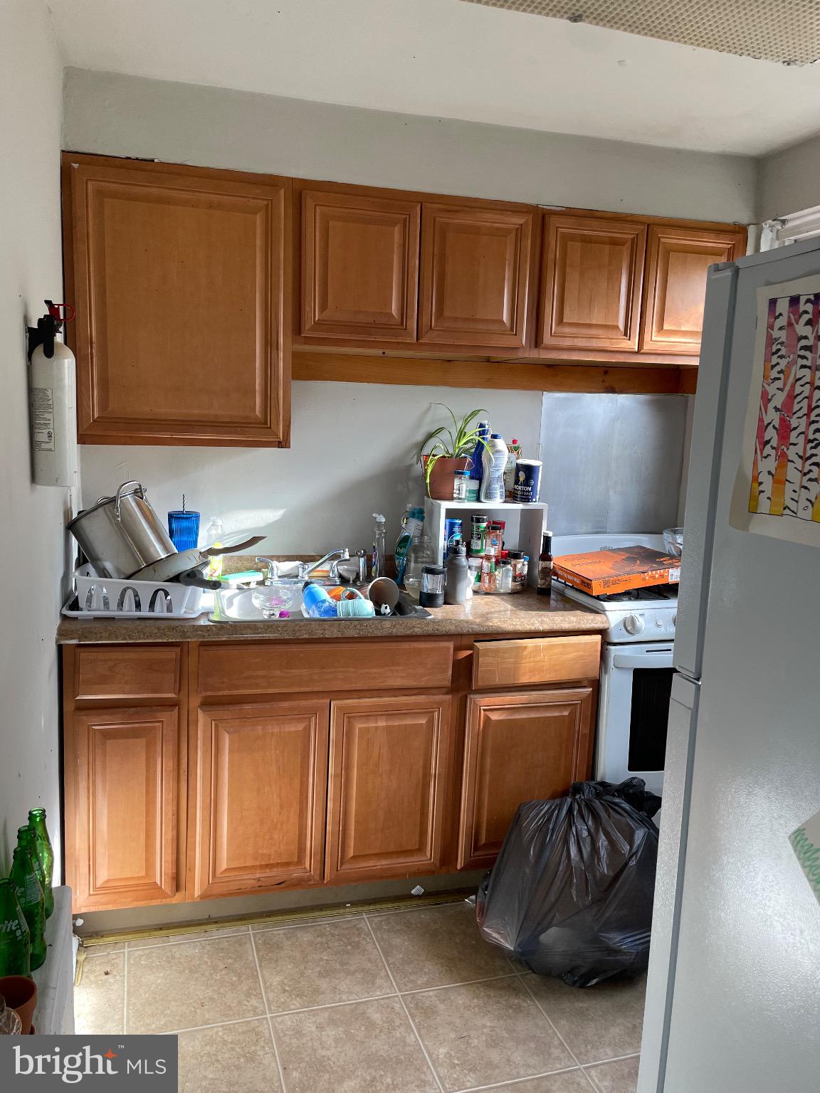 213 Gray Street Chester, PA 19013 - Photo 9 of 38 a kitchen with stainless steel appliances granite countertop a sink and cabinets