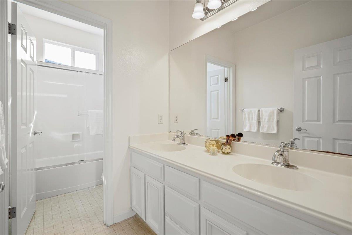 2144 Gullane Way Gilroy, CA 95020 - Photo 16 of 22 a bathroom with double sink and a mirror