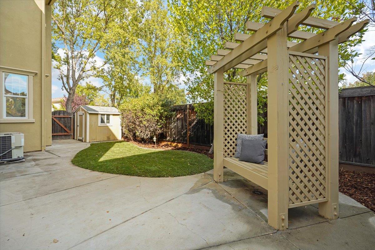 2144 Gullane Way Gilroy, CA 95020 - Photo 19 of 22 a view of a wooden house with a small yard and wooden fence
