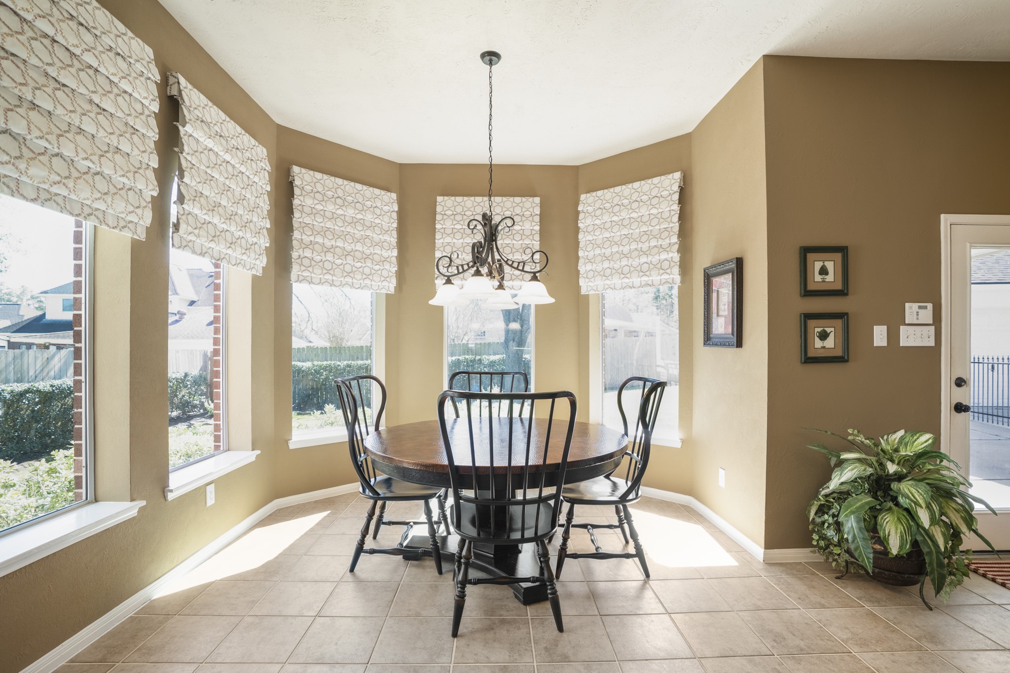 6615 Haughton Drive Spring, TX 77389 - Photo 16 of 50 The breakfast area feels bright and inviting, wrapped in bay windows that surround the table with natural light. Instead of a single wall of glass, this space is nearly encircled by windows, giving it an airy, open feel throughout the day. The angles of the bay add dimension, while still keeping the table comfortably centered within the room.
It’s an easy spot to start the morning or wind down at the end of the day, all with a clear view of the backyard beyond.