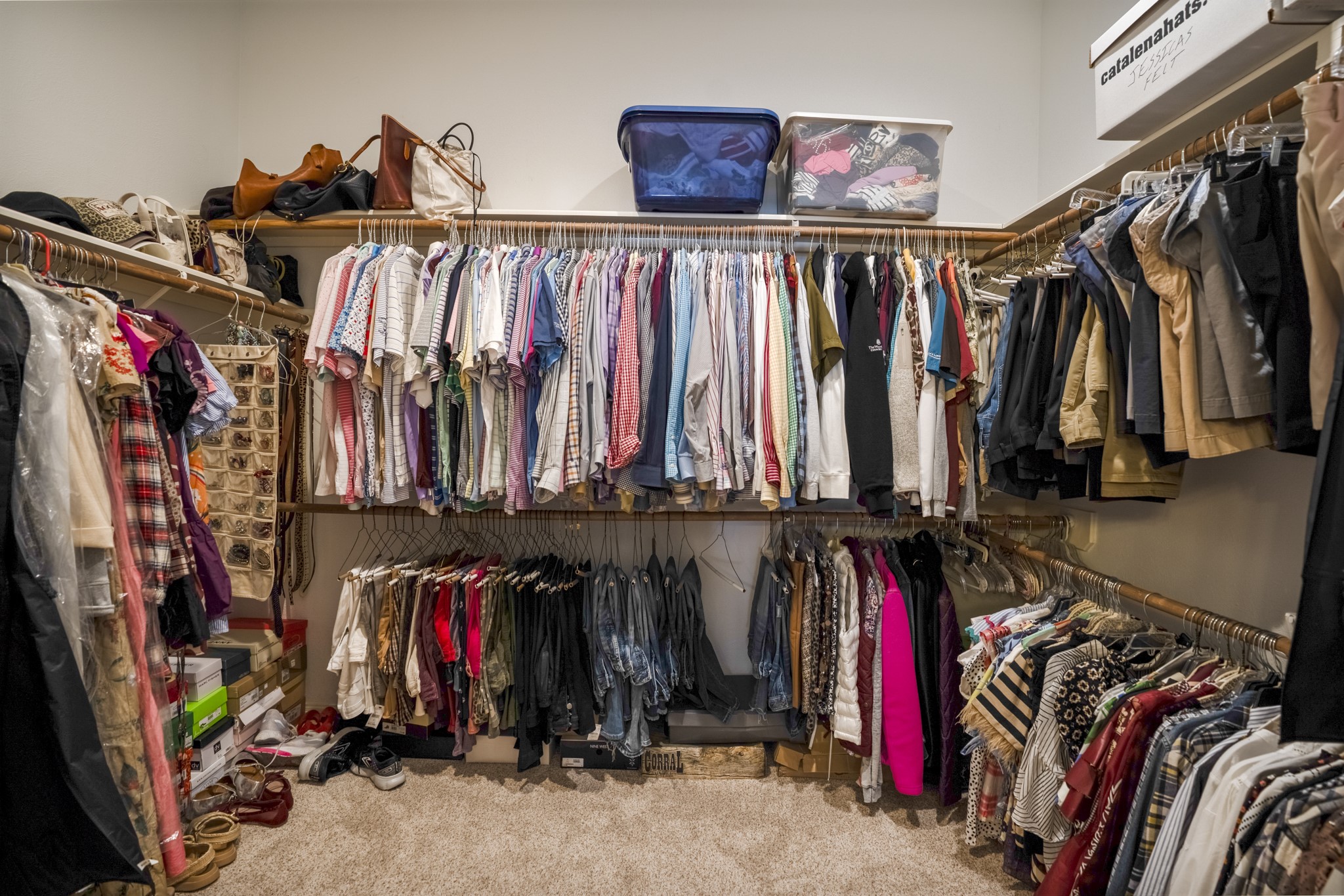 6615 Haughton Drive Spring, TX 77389 - Photo 21 of 50 Just beyond the bathroom, the walk-in closet offers the kind of space that keeps everything in its place. With built-in shelving and multiple hanging sections, there’s room for seasonal wardrobes, shoes, and everyday essentials without compromise. It’s organized, accessible, and thoughtfully laid out — an extension of the primary suite that supports how you actually live.