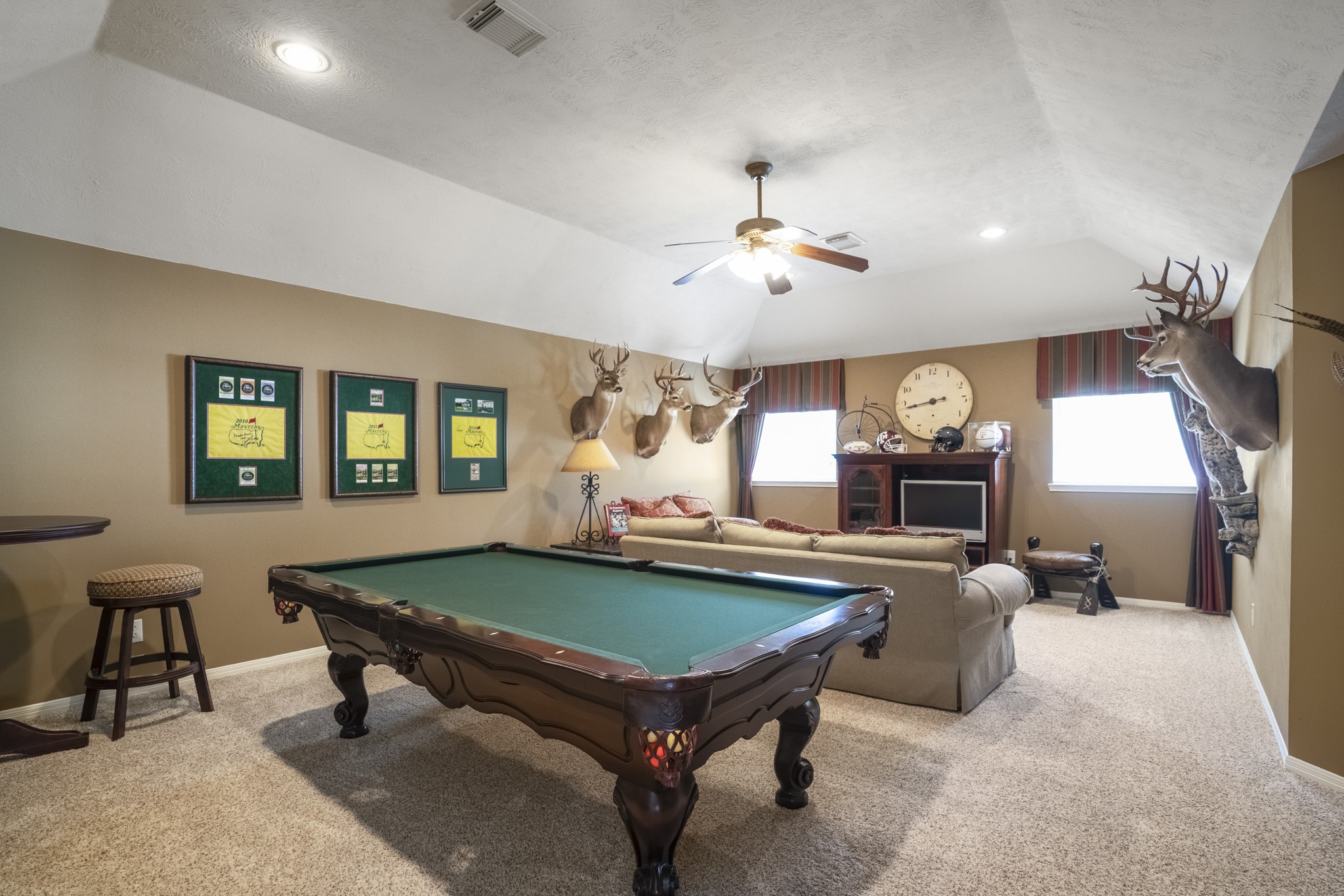 6615 Haughton Drive Spring, TX 77389 - Photo 26 of 50 From this side of the game room, you can see just how flexible this upstairs living space can be. There’s ample room for recreation, seating, and even additional uses depending on your needs. Windows along the wall bring in natural light, while the open layout keeps the space feeling relaxed and easy to enjoy.