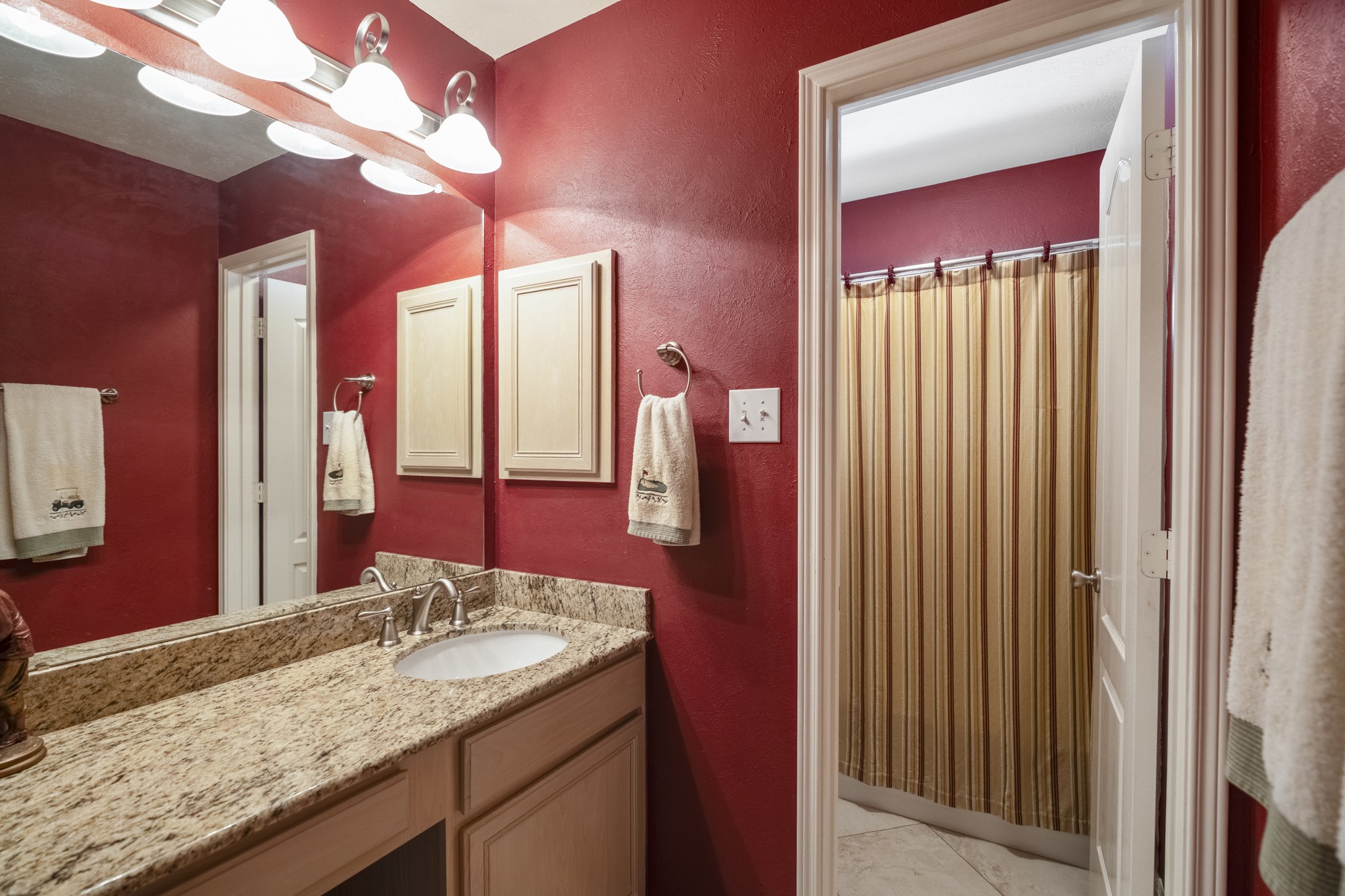 6615 Haughton Drive Spring, TX 77389 - Photo 30 of 50 One of the two full bathrooms upstairs, this space offers a long vanity with generous counter space and storage below. The layout includes a separate, private water closet that houses the toilet and shower area — keeping the sink and vanity accessible even when the rest of the bath is in use.