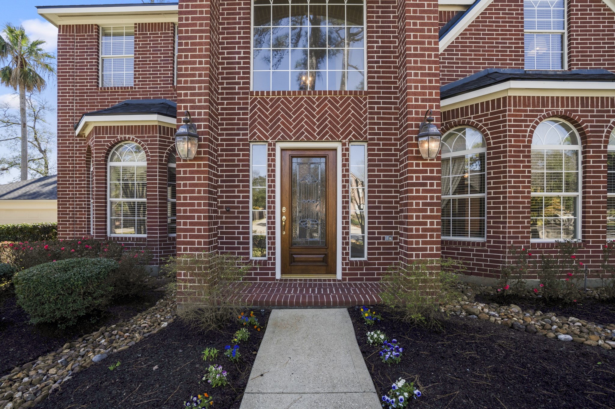 6615 Haughton Drive Spring, TX 77389 - Photo 3 of 50 As we make our way to the front door, the details come into focus — bay windows that add dimension to the façade, arched windows that echo the home’s elegant style, and coach lights that frame the entry in the evenings. The brickwork carries through with warmth and depth, while the covered porch creates a welcoming transition before stepping inside.
Now, let’s open the door and see how the home unfolds from the entry.