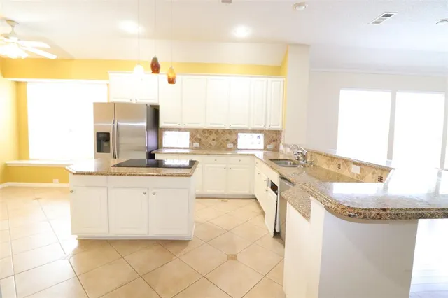 a kitchen with granite countertop a sink and a stove